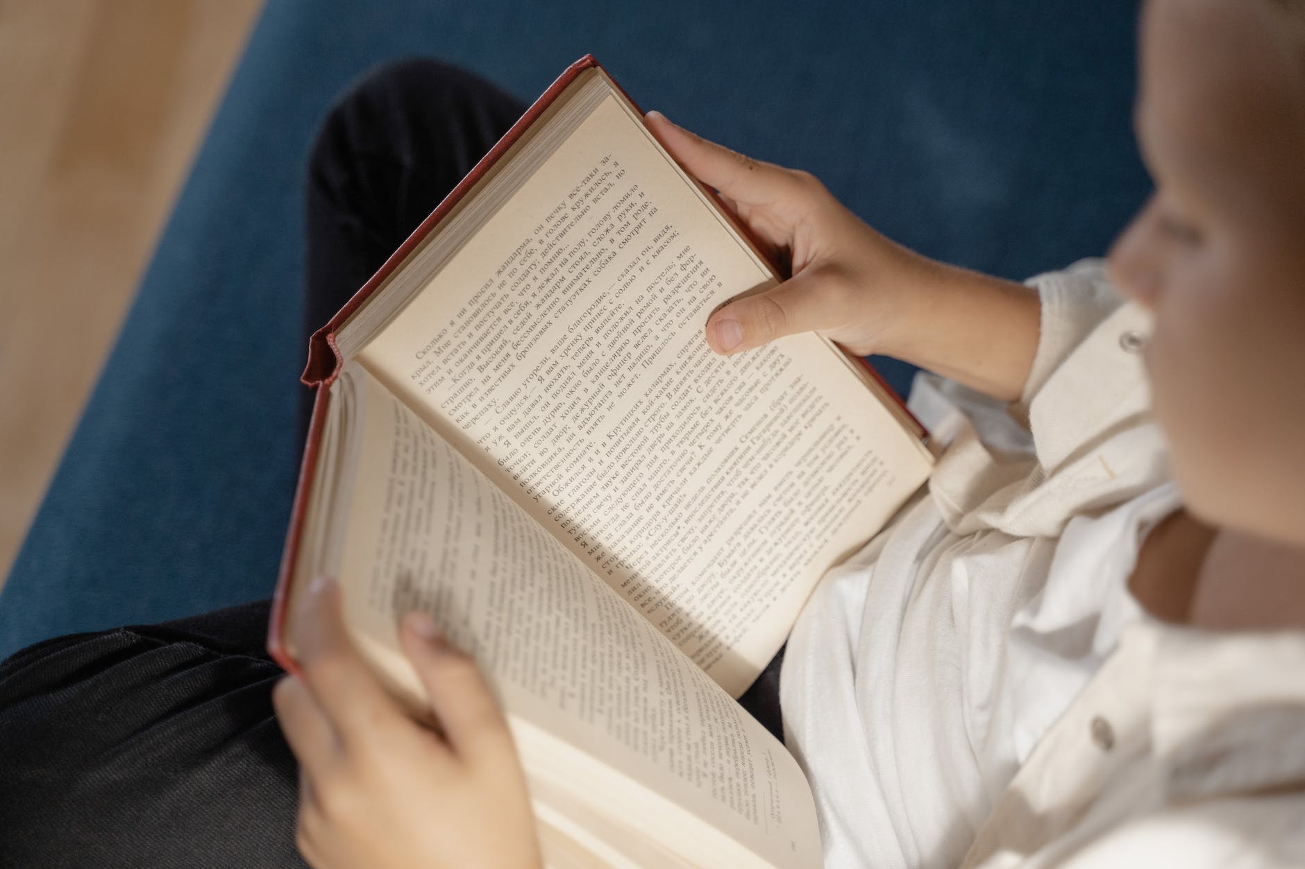 person holding book on lap