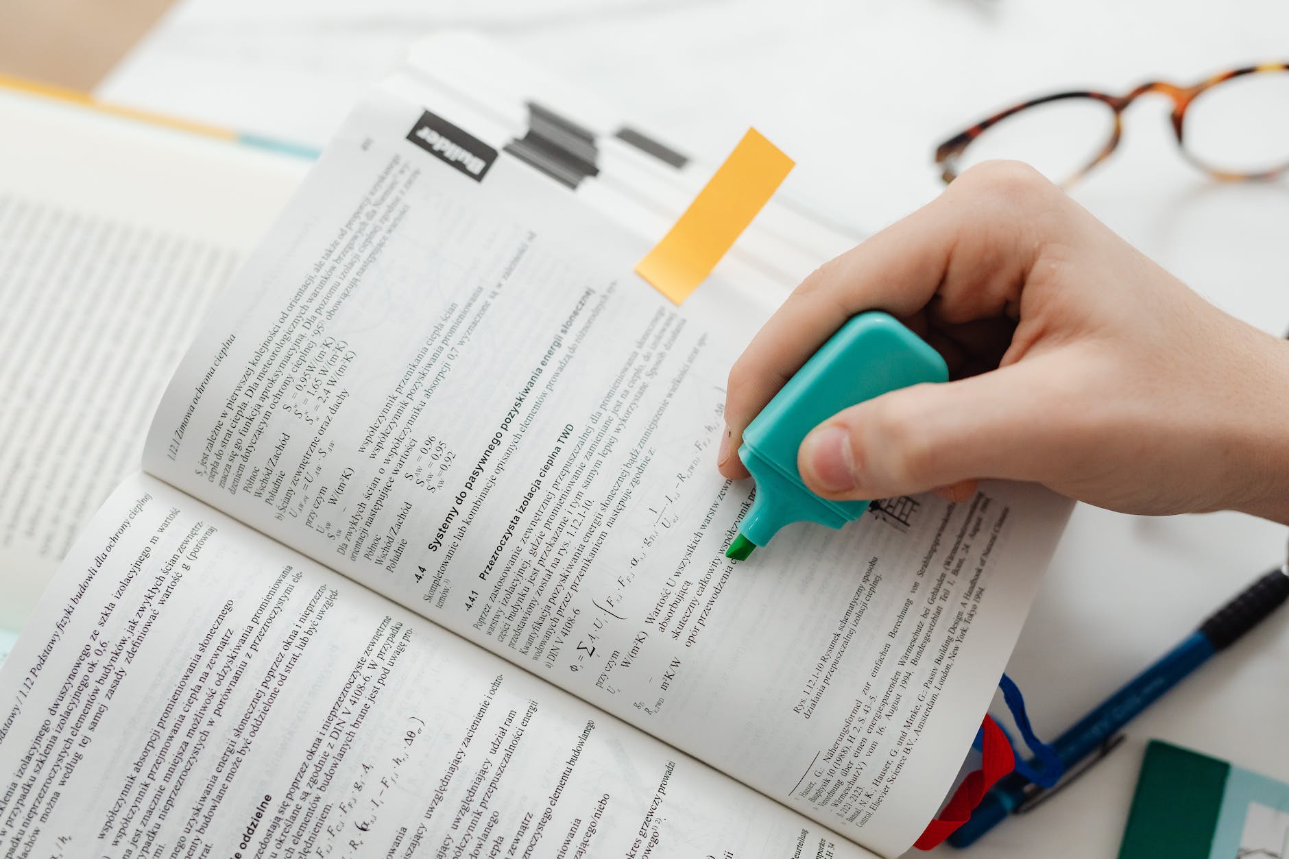 person using a blue highlighter pen