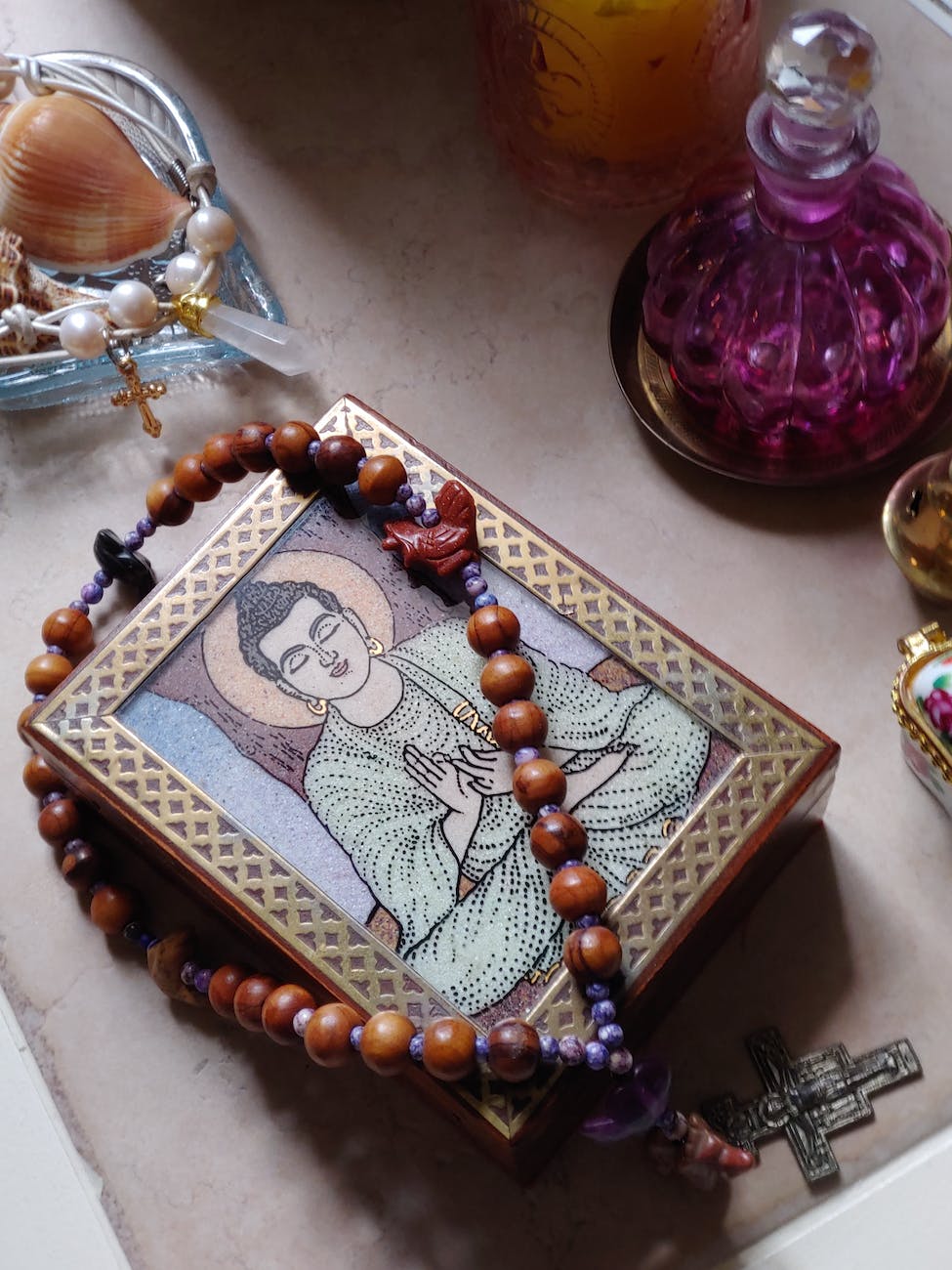 prayer beads on table with buddhist temple