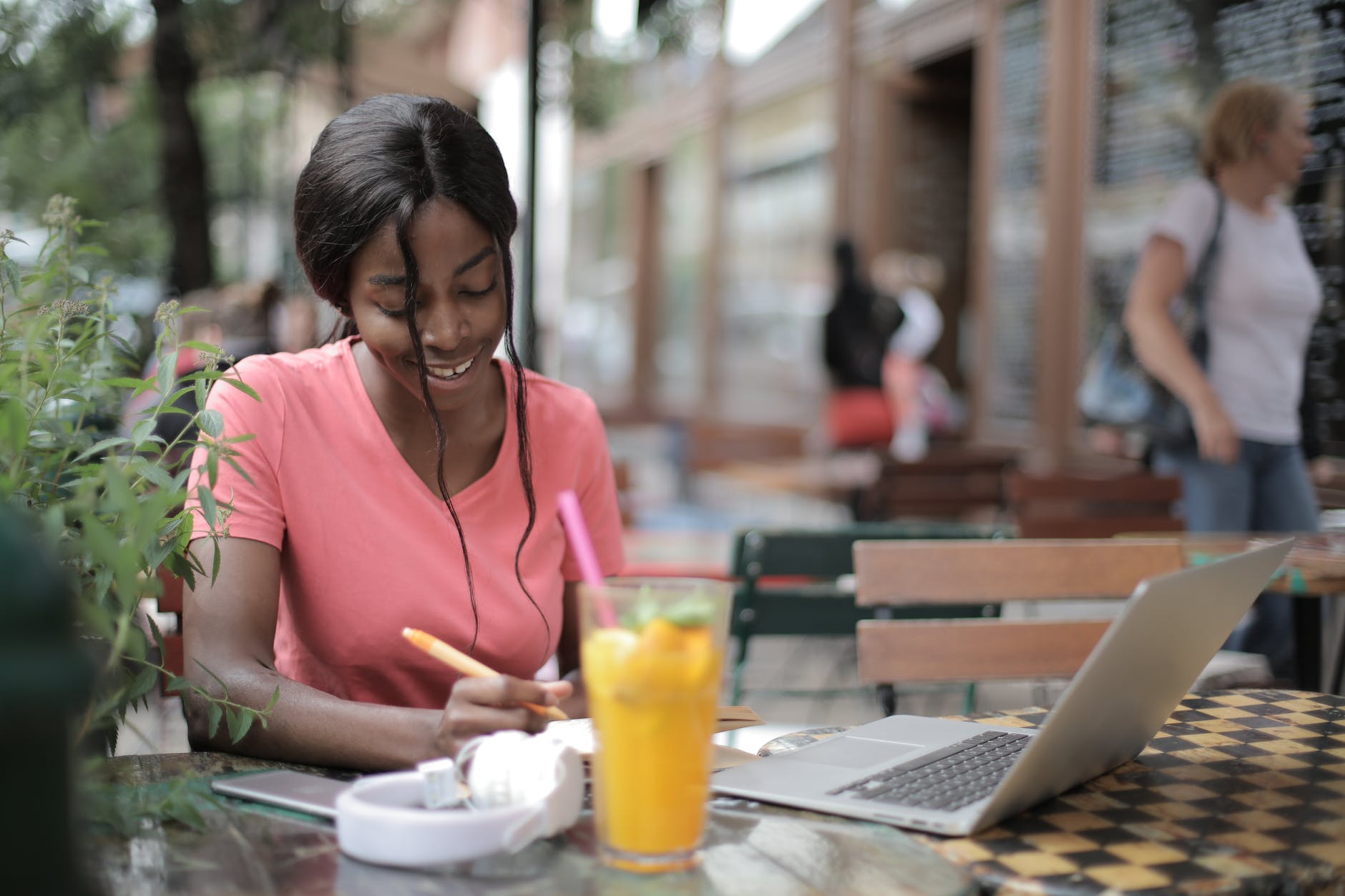 woman in pink scoop neck shirt sitting by the table