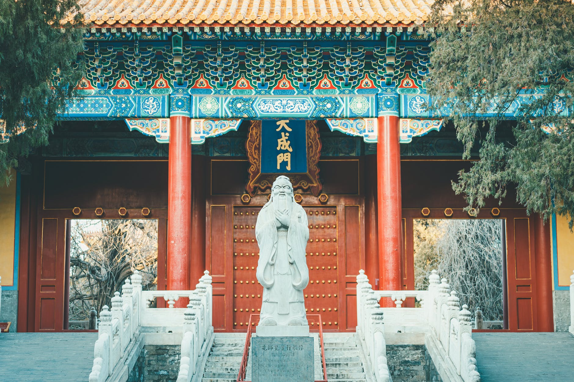 gray concrete statue near the wooden door