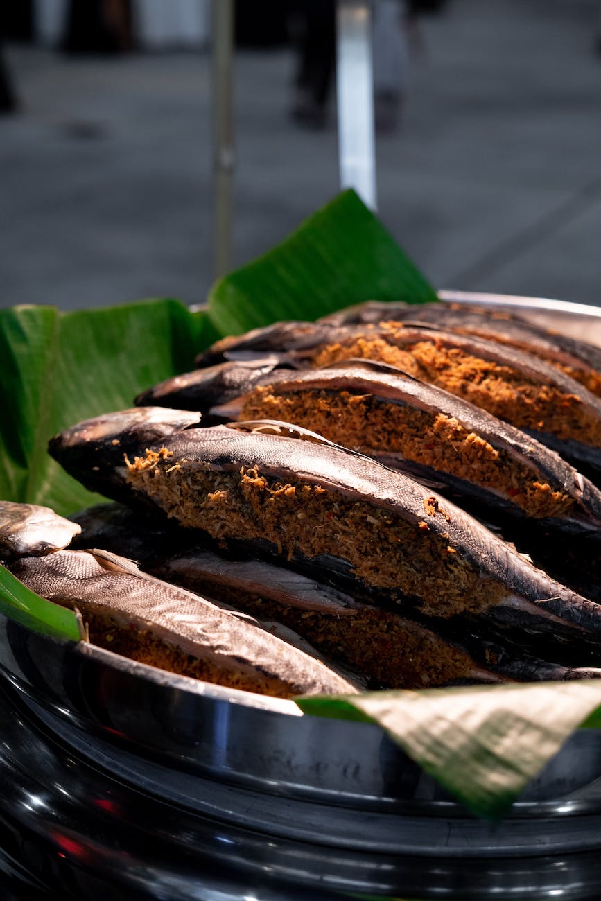 cooked fish on green banana leaf