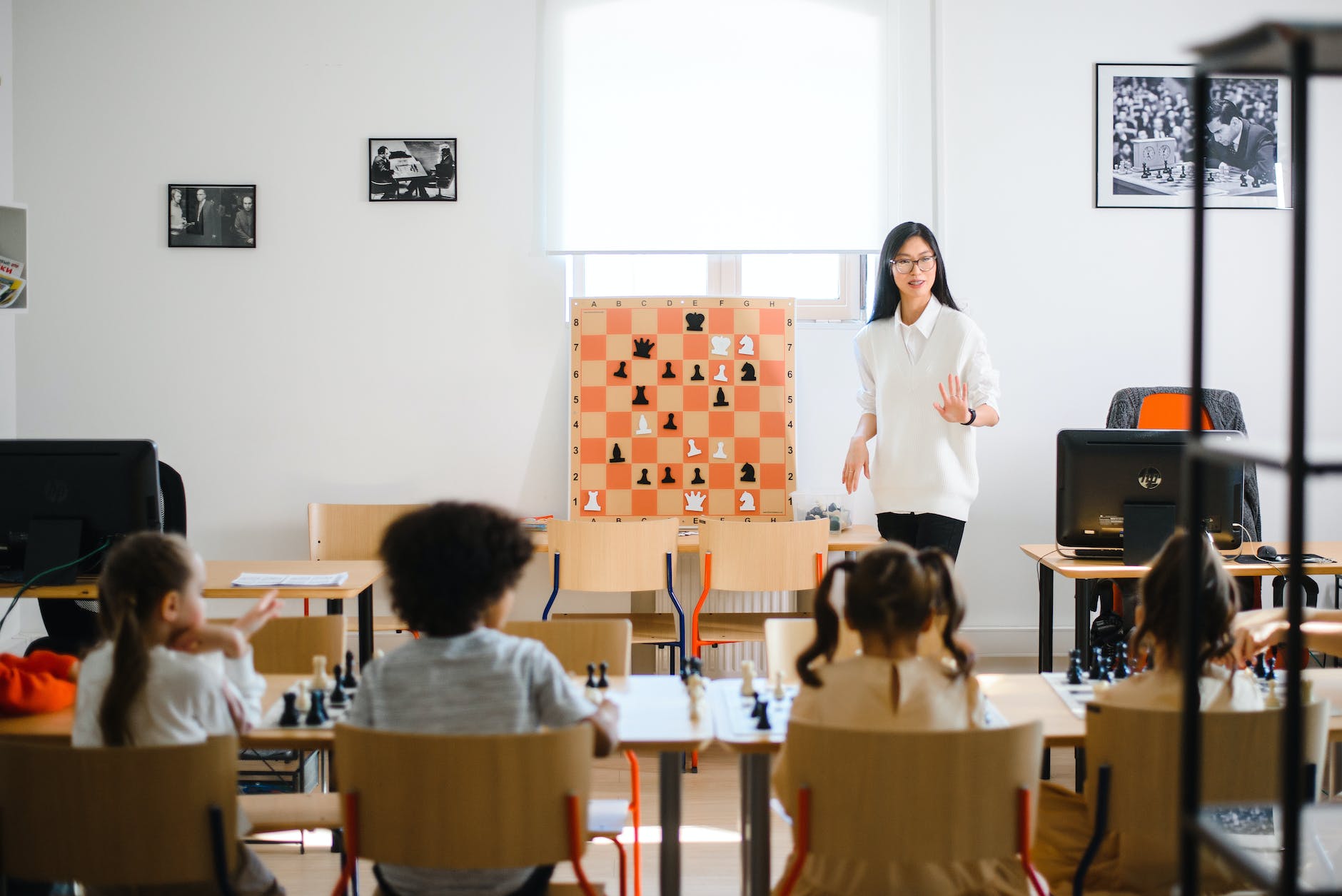 a woman standing in front of young children