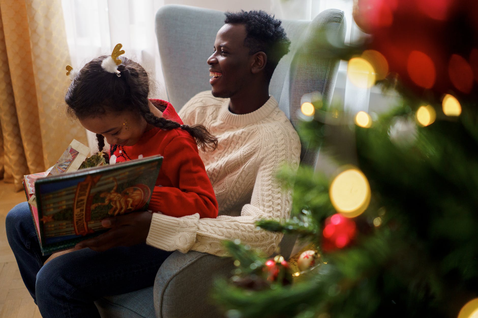 dad and daughter having fun while reading a fairy tale book